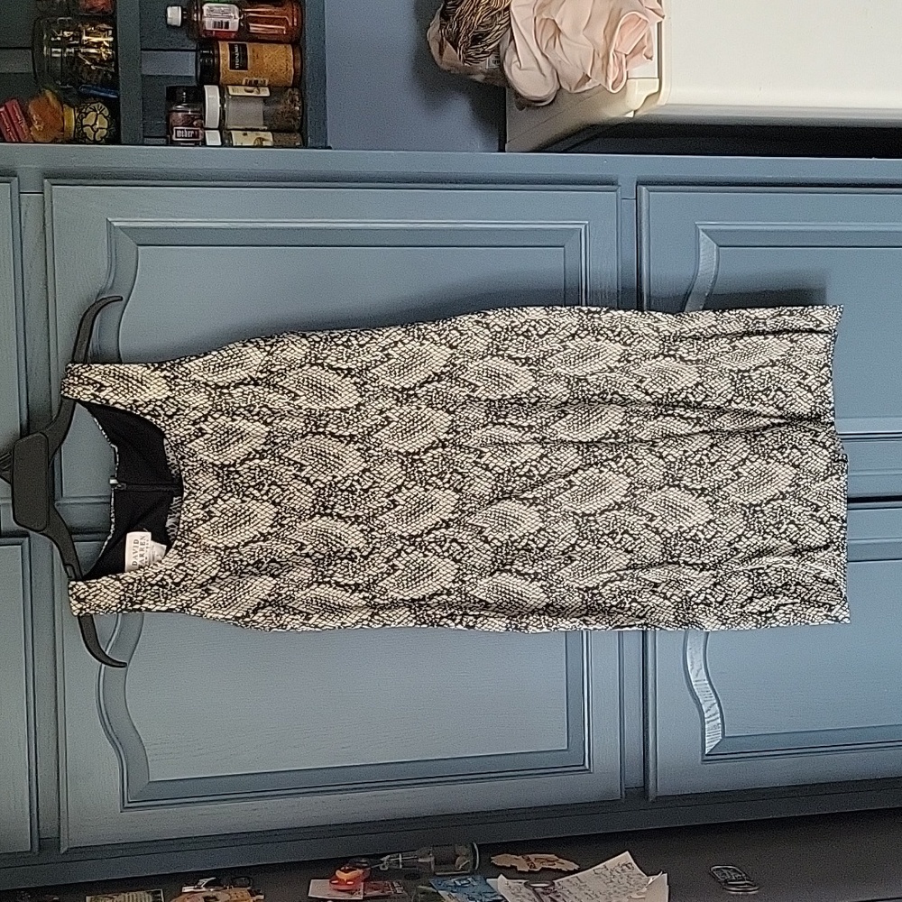 Like new faux snake skin dress. Zip in back. Small slit in back
